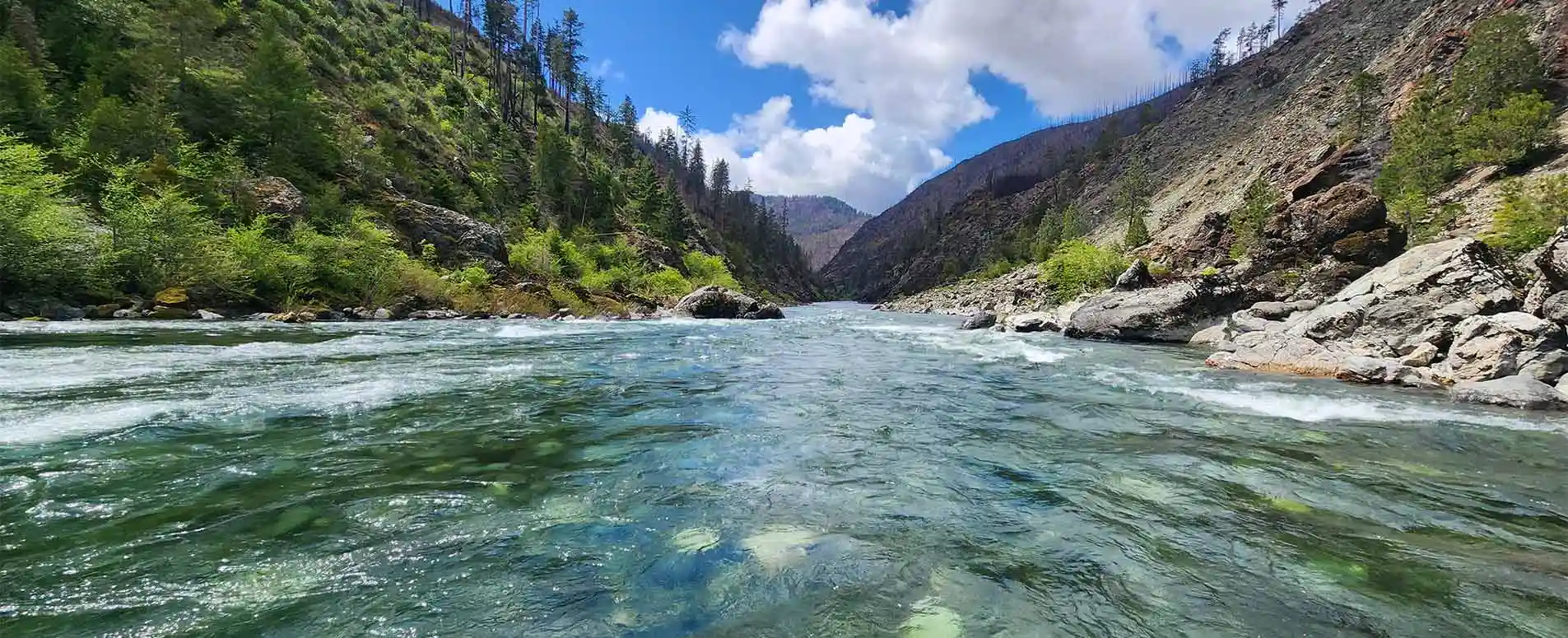 Beautiful blue sky, white clouds looking downstream on the river